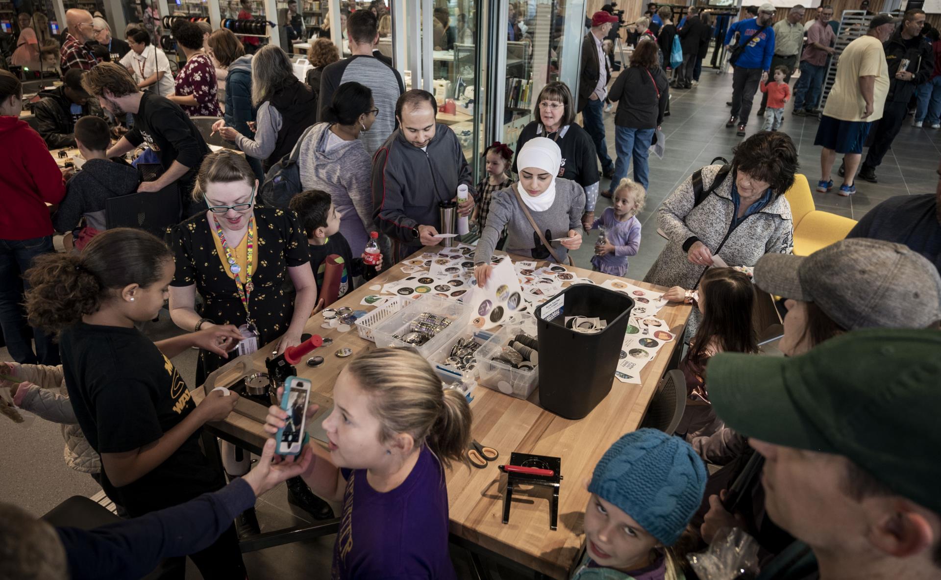 people making buttons on opening day